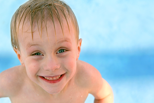 Happy Young Child Smiling in Swimming Pool