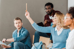 White student raising hand 